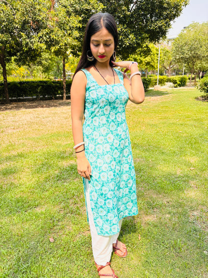 Model in Khilan Collection turquoise floral printed long cotton kurti with sleeveless design and deep back – front pose in garden