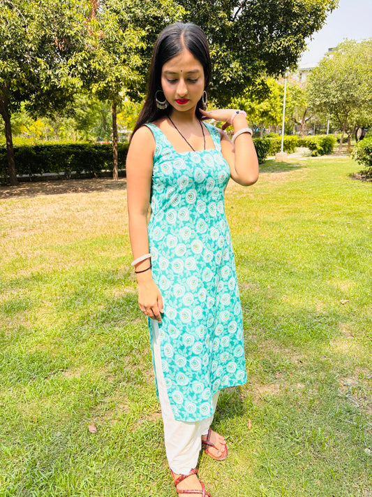 Model in Khilan Collection turquoise floral printed long cotton kurti with sleeveless design and deep back – front pose in garden